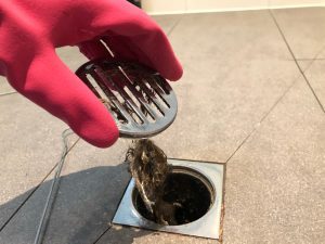 Hair being removed from clogged drain