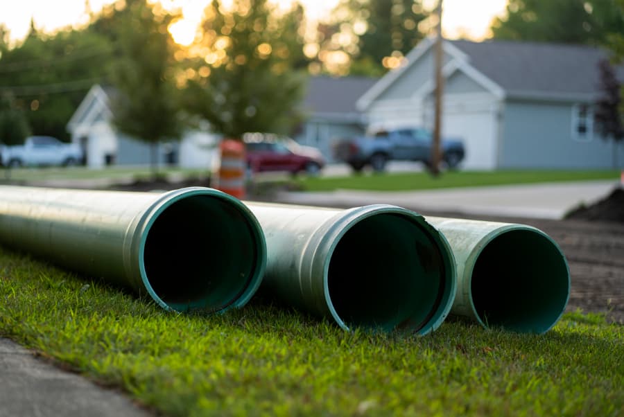 Sewer pipes on the ground awaiting installation