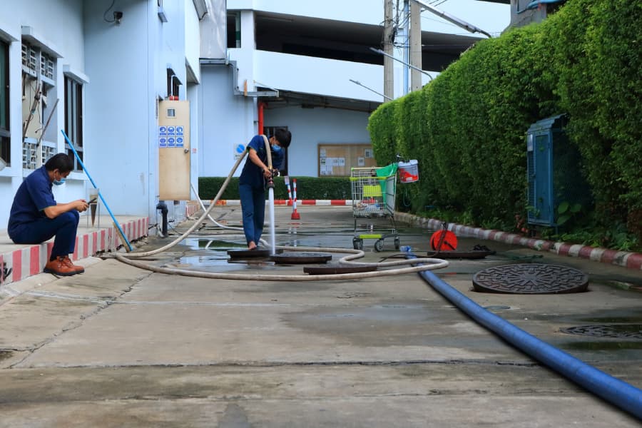 Technicians clean new lines at apartment complex after trenchless sewer repair