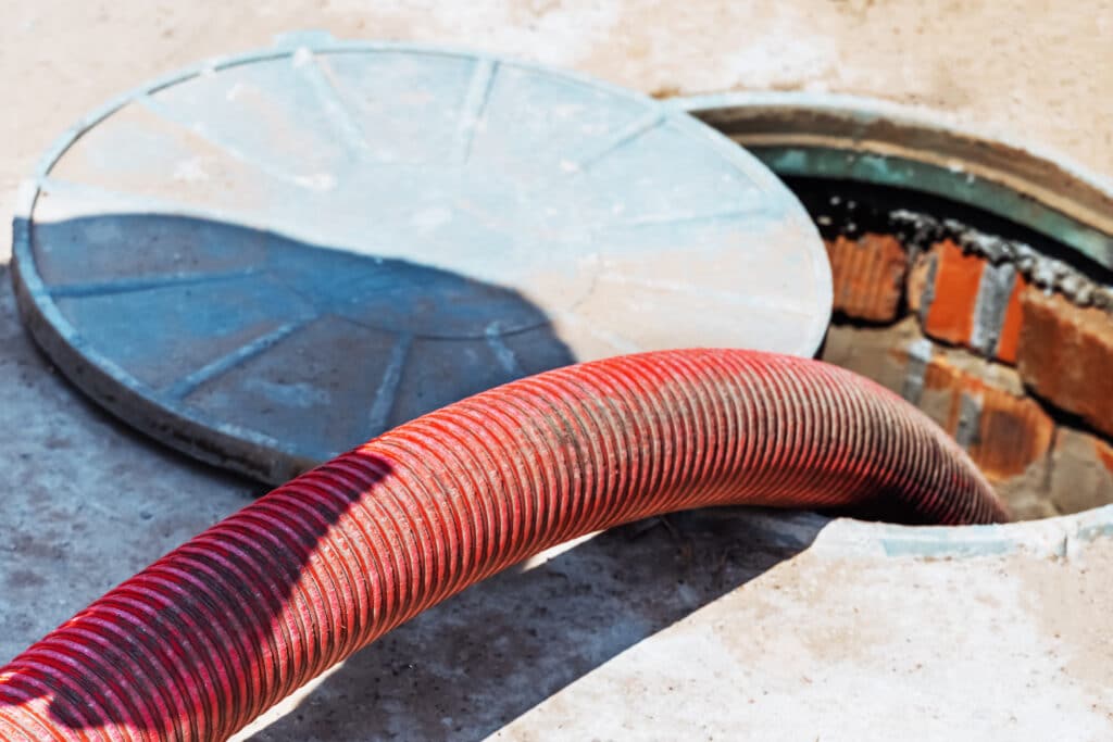 Hose pumping out household septic tank