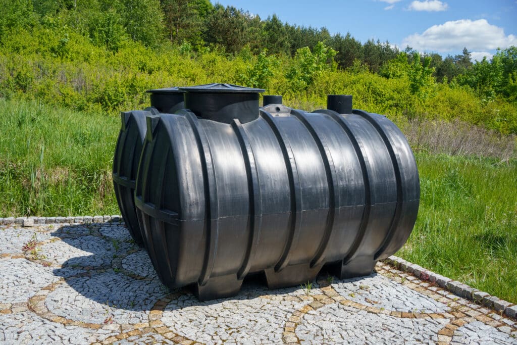 Two septic tanks outdoors on concrete ground
